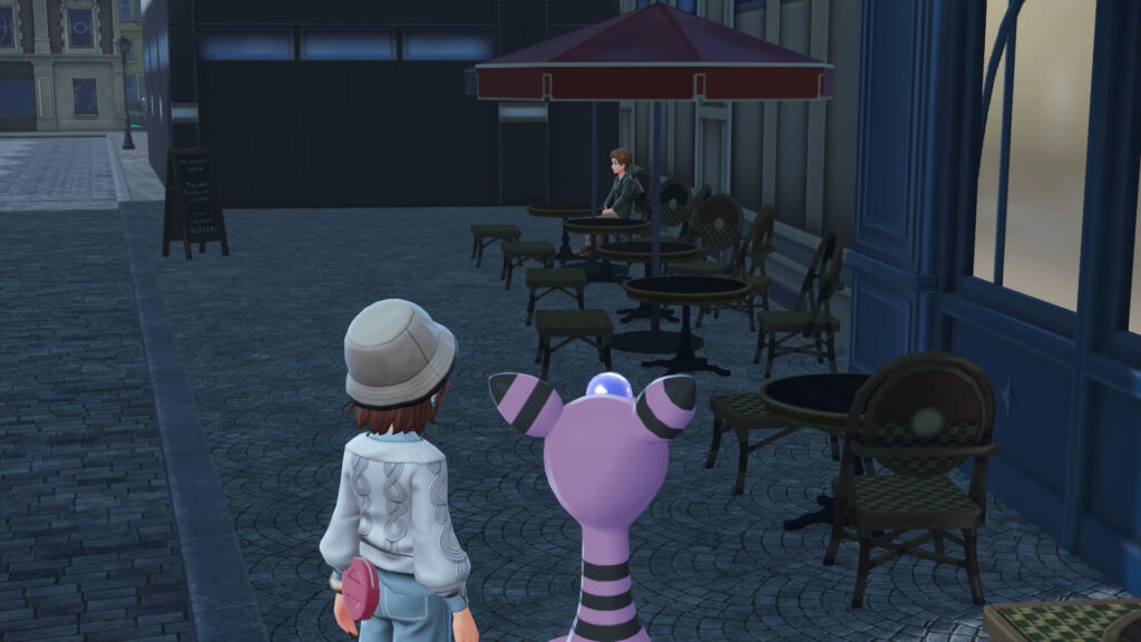 ポケモンレジェンズZAにあるカフェ・カンコドールの隅の席にいる男性客